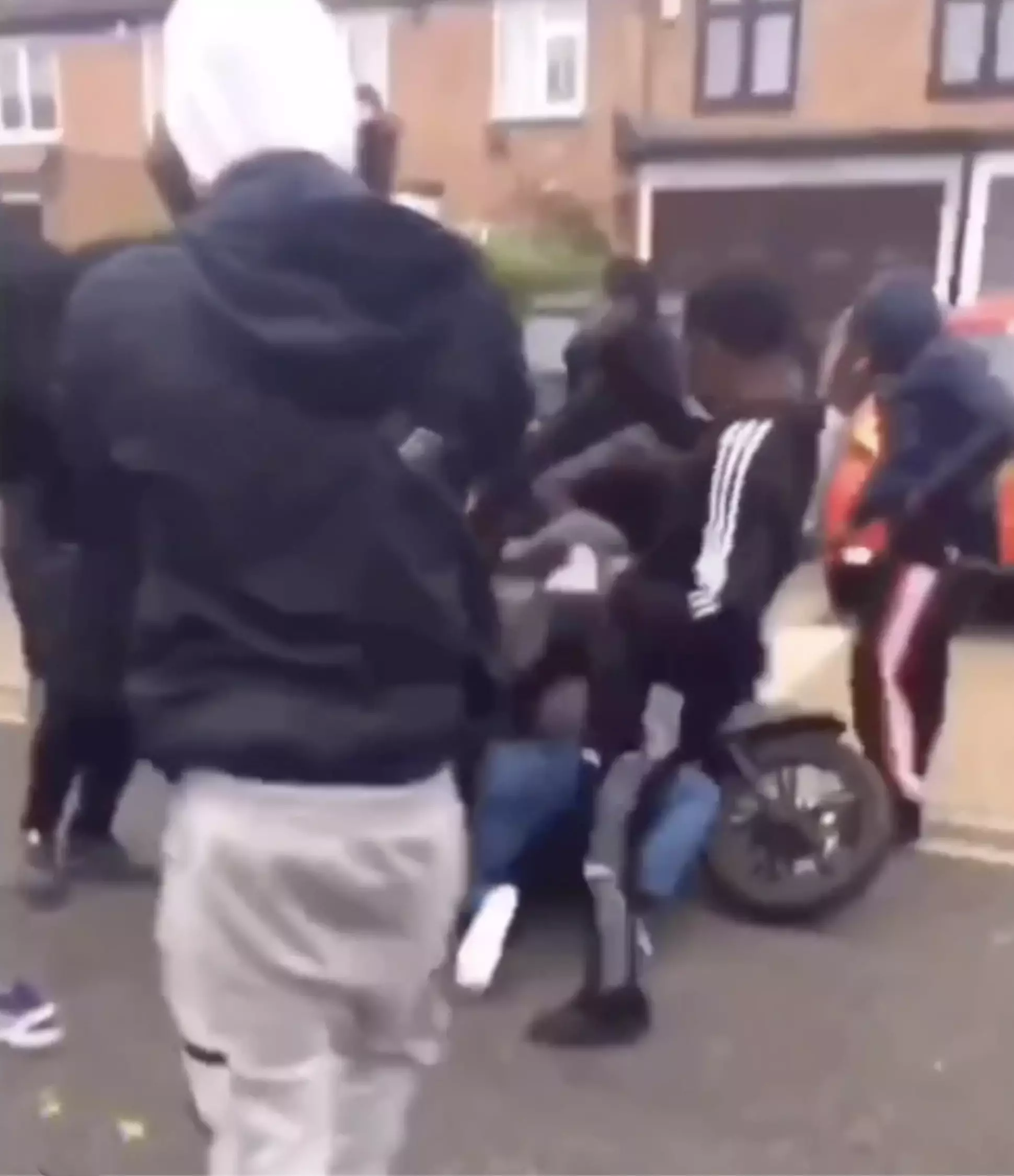 The driver is knocked to the floor before being kicked in the head by the gang.