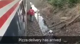 LAD Delivery Driver Brings Pizza To Hungry Passengers Trapped On Stalled Train