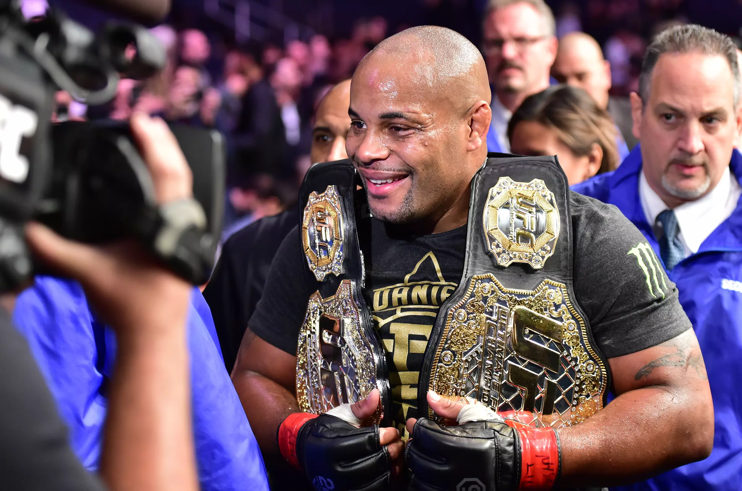 Daniel Cormier pictured with his light heavyweight and heavyweight belts.