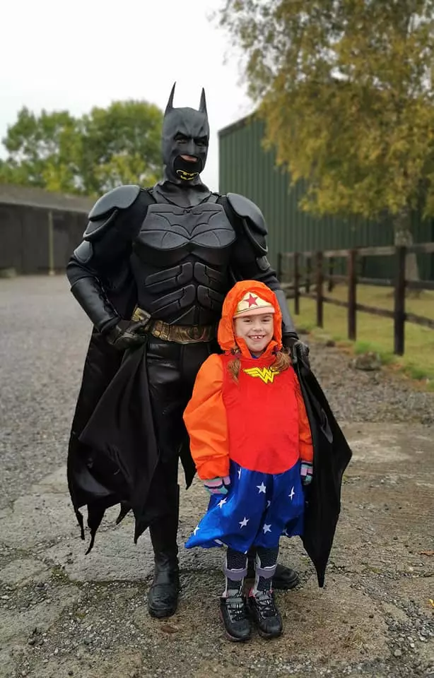 Carmela was greeted by Batman at the finish line.
