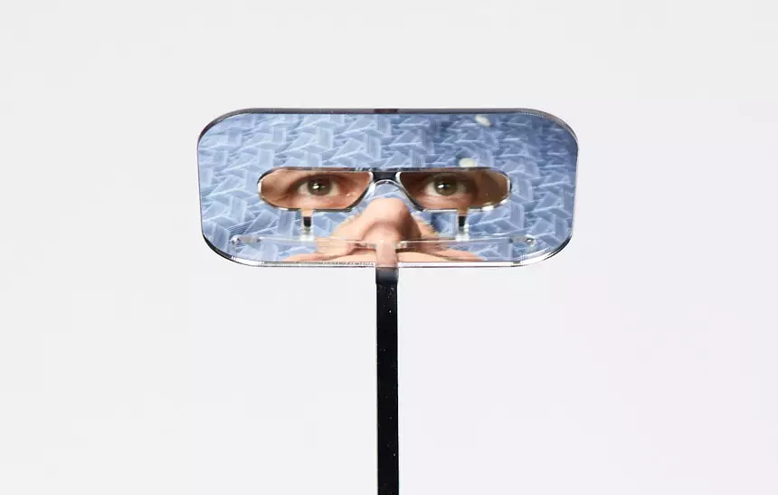 The glasses use angled mirrors to allow the wearer to see over the heads of taller people.