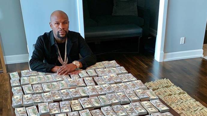 Floyd Mayweather responds to claims he's broke by showing off wads of cash  and $20 million watches