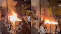 Couple’s reaction to street in flames behind them is ‘most Parisian thing’ ever seen