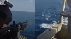 Security guards with machine guns fire at Somali pirates trying to attack ship
