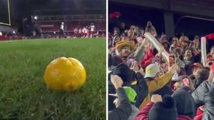 American football fans launch lemons onto the field after their beer snake is taken away