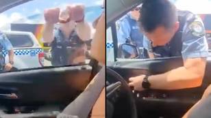 Police rip off woman’s window after she refused to get out of the car