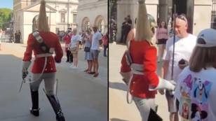 Tourist refuses to move out of Queen Guard's way as he marches on