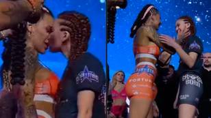 Two MMA fighters surprise crowd as they kiss during pre-fight faceoff