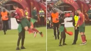 Pitch invader lifts Cristiano Ronaldo off the ground before doing his 'Siu' celebration in bizarre incident