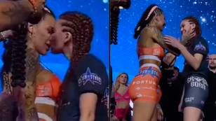 Two MMA fighters surprise crowd as they kiss during pre-fight faceoff