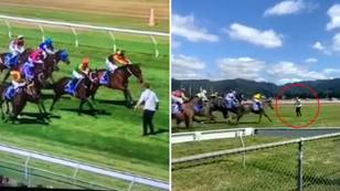 Terrifying Footage Shows Man Risking His Life By Running On Track Towards Horses During Race 