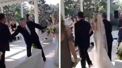 Moment father-of-the-bride interrupts wedding to include stepfather in walking daughter down the aisle