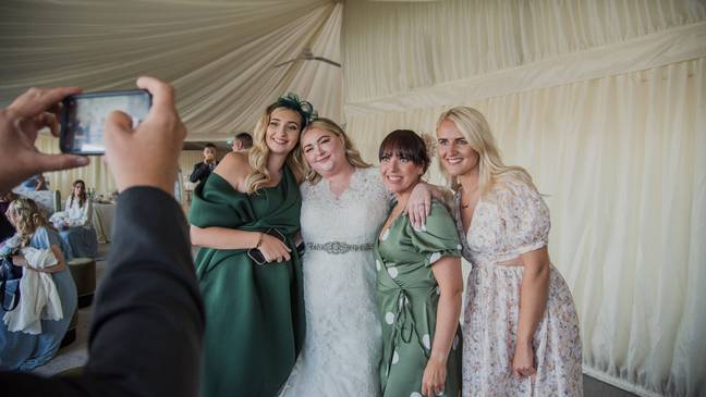 Kayley entered the party singing along to Lizzo's 'Good as Hell' and punched off the top tier of her wedding cake. Credit: Neil Jones Photography/SWNS