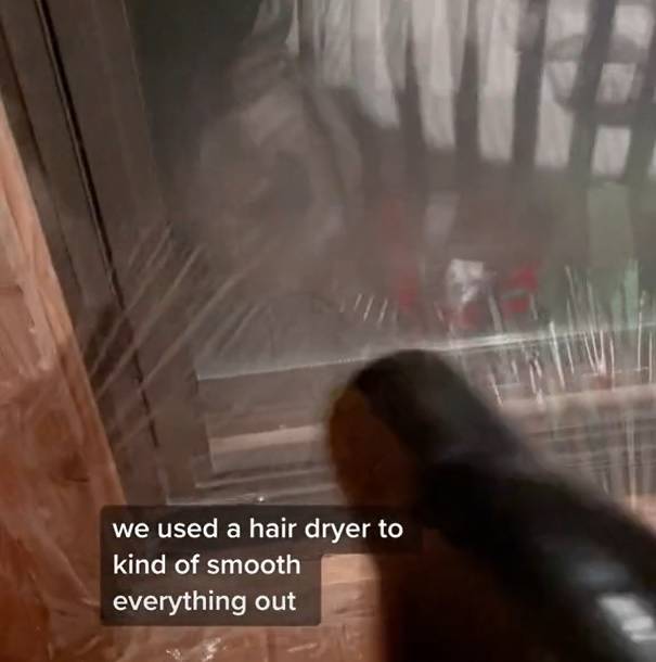Clever use of a hairdryer is crucial to iron out the wrinkles and seal the windows. Credit: TikTok/@shay_creates