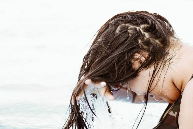 Shampoo can strip your hair of it's natural moisture, according to experts. [Credit: Unsplash]