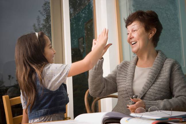 An expert has warned parents not to high-five their kids. Credit: Tetra Images, LLC/Alamy Stock Photo
