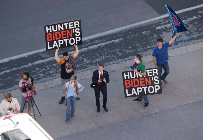 Donald Trump supporters with 'Hunter Biden laptop' signs. Credit: Bob Daemmrich/Alamy Stock Photo