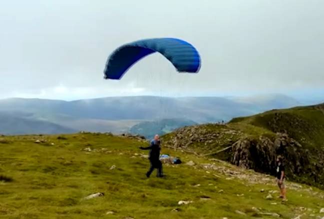 Tom Cruise paraglided off a hill for one of his latest Mission Impossible stunts. Credit: YouTube/ExtraTV
