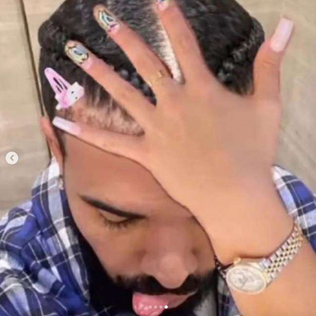The rapper took to the photo-sharing site to share a selfie with what appears to be a woman’s hand on his head. Credit: champagnepapi/Instagram
