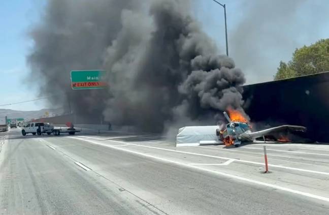 The heart-pounding moment a small plane crashed into a motorway in California has been caught on film. Credit: Corona Fire Department 
