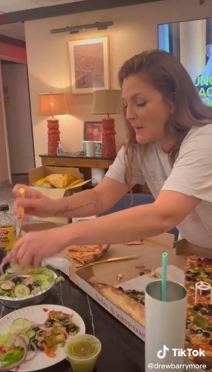 Drew scraps off the topping to mix it with a salad. Credit: @drewbarrymore / Tiktok