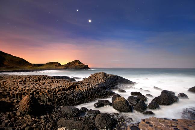 Jupiter and Venus visible in the sky from the Giants Causeway. Credit: Stephen Emerson / Alamy Stock Photo