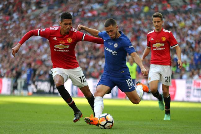 Smalling attempts to challenge Chelsea winger Eden Hazard. (Image Credit: Alamy)