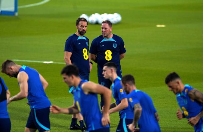  Southgate and assistant Steve Holland watch England players train in Qatar. (Image Credit: Alamy)