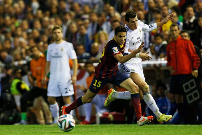 Bartra tries to hold off Bale. Image: PA Images