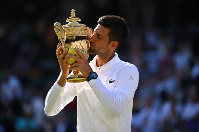 Djokovic with the trophy he's won four times in-a-row. Image: Alamy