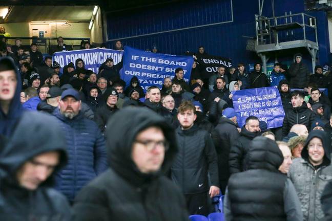 Everton fans with signs protesting the owners and board. Image: Alamy