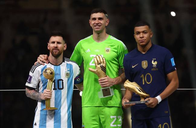 Kylian Mbappe was forced to pose awkwardly alongside Emi Martinez after the World Cup final. (Image: Alamy)