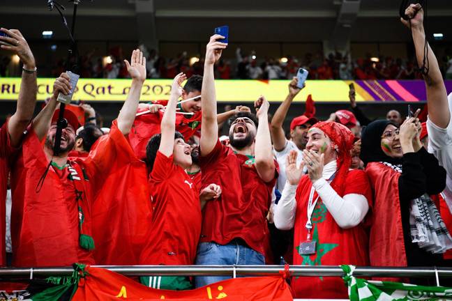 Morocco fans celebrate their win over Belgium. (Image Credit: Alamy)