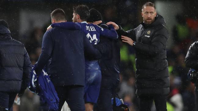 Ben Chilwell of Chelsea is helped off of the pitch past Graham Potter following injury. (Alamy)
