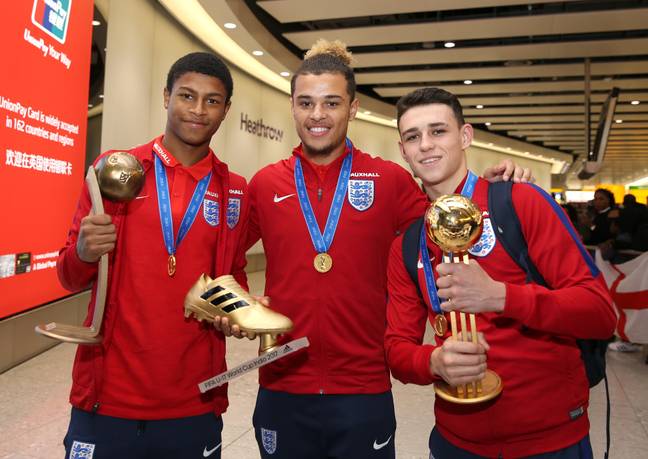 Rhian Brewster, Joel Latibeaudiere and Phil Foden pose for a photo as the Under-17 World Cup winning side arrive back to the UK. Image credit: Alamy