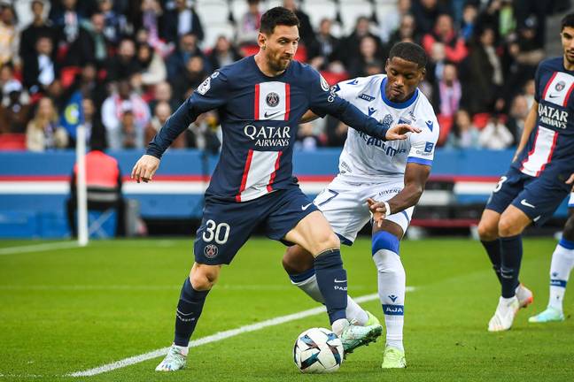 Messi holds off Julian Jeanvier. (Image Credit: Alamy)