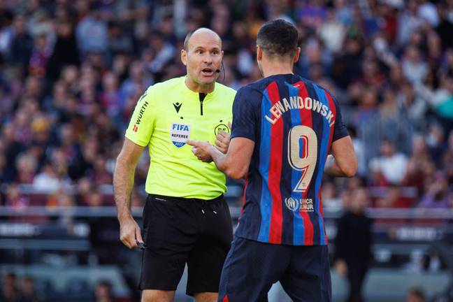 Mathieu Lahoz habla con Robert Lewandowski durante el Barcelona-Espanyol.  Foto: Alami