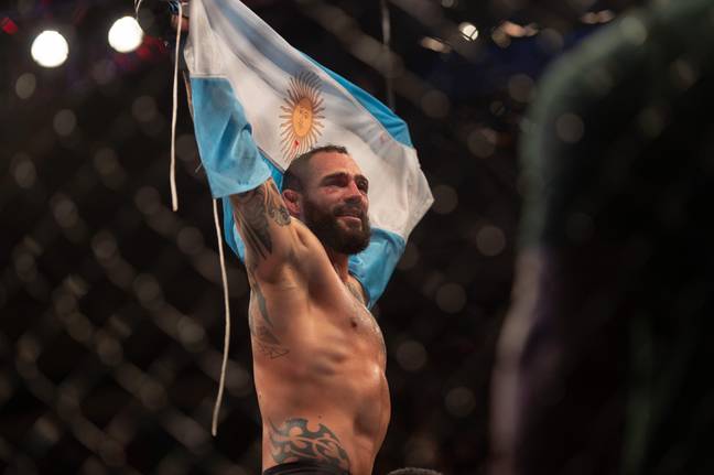 Santiago Ponzinibbio celebrates with a Argentina flag following a UFC win. Image: Alamy 