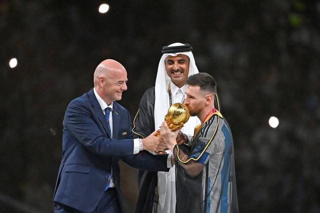 Gianni Infantino presents the World Cup to Lionel Messi. Image: Alamy 