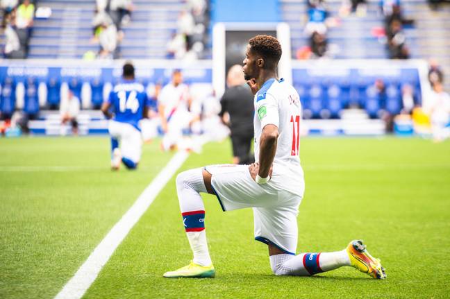 Crystal Palace forward Wilfried Zaha is one of the players who said he'd stop taking the knee as he felt it had lost impact. Credit: MB Media Solutions/Alamy Stock Photo