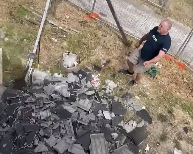 Adrian Padoin standing next to a huge pile of smashed roof tiles. Credit: Twitter/@ACurrentAffair9