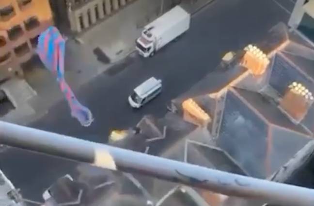 A bag of a man's poo soars through the air after he flung it off a crane in Dublin. Credit: @viralclipsirl/TikTok