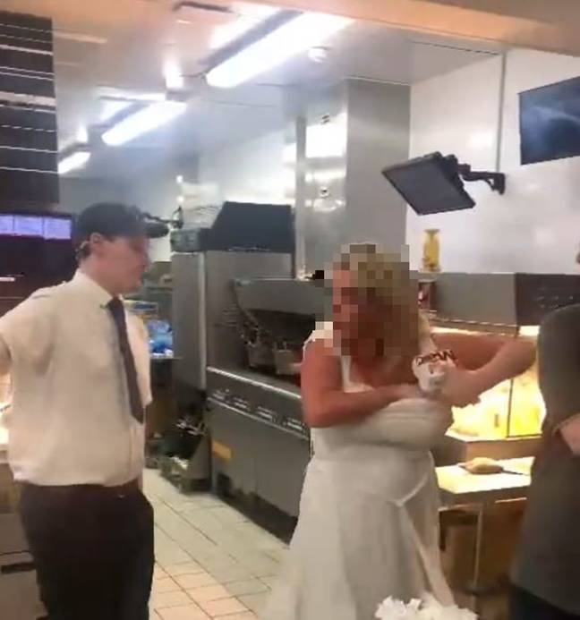 The woman grabbed a couple of burgers and shoved them in her bra. Credit: Deadline News