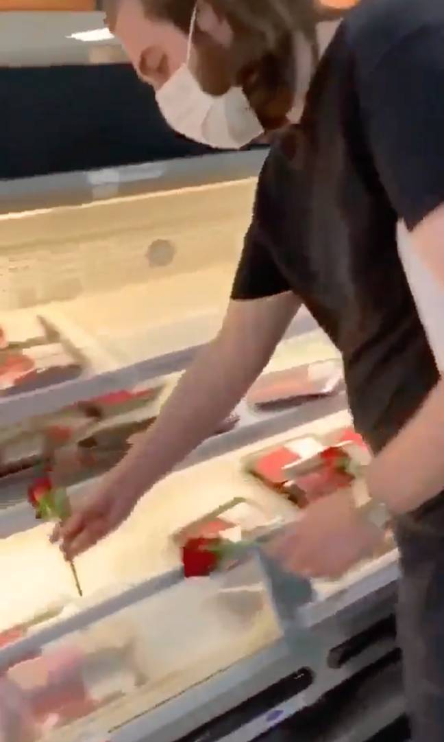 The vegans can be seen placing roses on top of the meat. Credit: RadioGenova/Twitter