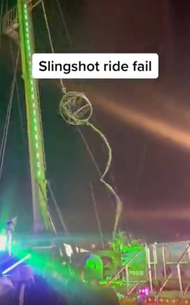 Slingshot Rriiddde Slingshot ride snaps at London's Winter Wonderland while two people are ...