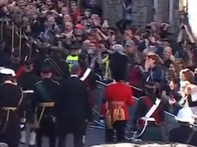 A protester was pulled away after shouting abuse at the Queen's coffin procession. Credit: Twitter
