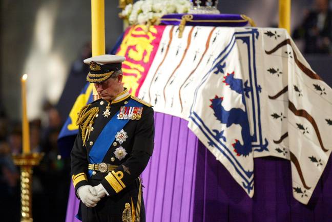 Then-Prince Charles standing beside the Queen Mother's coffin at Westminster Hall in 2002. Credit: PA Images/Alamy Stock Photo