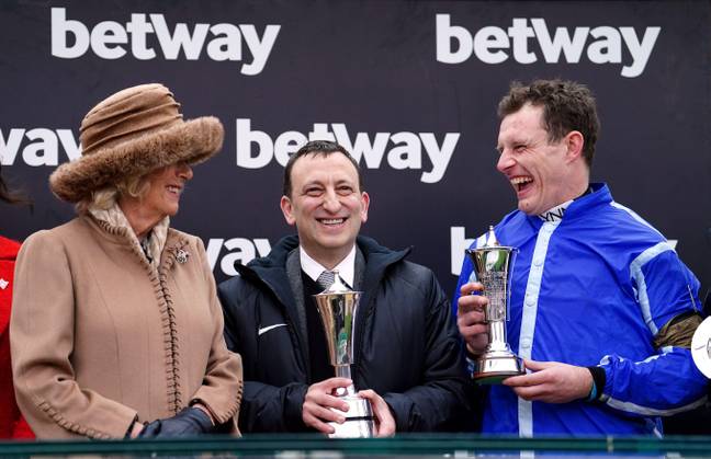 Jockey Paul Townend and owner Tony Bloom alongside the Queen Consort following victory in the Betway Queen Mother Champion Chase with Energumene. Credit:  PA Images/Alamy