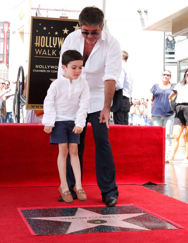 Simon with son Eric, who appears to be levitating. Credit: REUTERS / Alamy Stock Photo