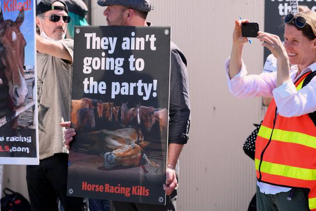 Anti racing protesters outside the track as 10,000 race goers descended on Flemington Racecourse for the 2021 Melbourne Cup, taking place in a post lockdown Melbourne for the first time. Credit: Michael Currie/Speed Media/Alamy.